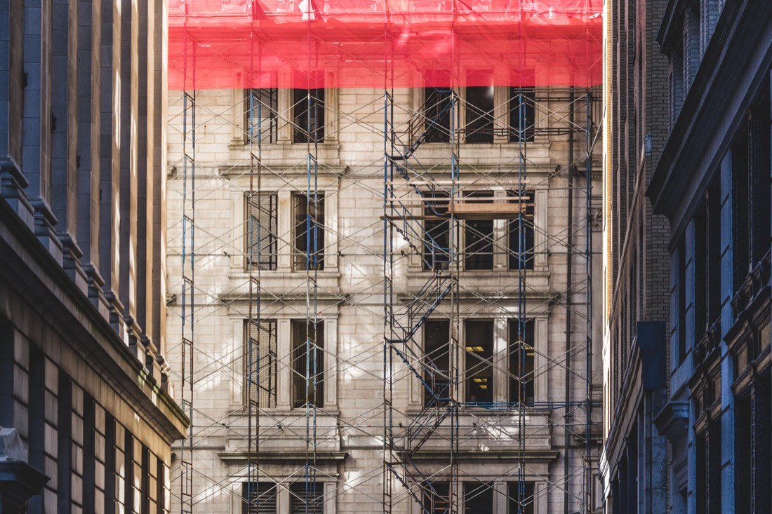 Palazzo storico coperto da ponteggi durante i lavori, metafora della migrazione di un sito